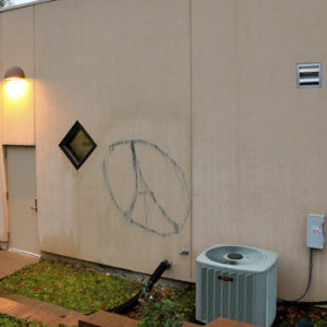 Graffiti in the shape of the Eiffel Tower inside a circle is painted on the side of the Islamic Center in Omaha, Neb., Tuesday, Nov. 17, 2015. A Muslim civil rights group wants the FBI and local police to investigate the vandalism as possible hate crime, that may be related to the Paris terror attacks. (AP Photo/Nati Harnik)