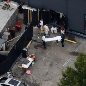 Investigators work the scene following a mass shooting at the Pulse gay nightclub in Orlando Florida, U.S. June 12, 2016. REUTERS/Carlo Allegri - RTX2FUWJ