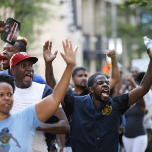 Demonstrators march through downtown Atlanta to protest the shootings of two black men by police officers  Friday, July 8, 2016. Thousands of people marched along the streets of downtown to protest the recent police shootings of African-Americans. Atlanta Police Chief George Turner and Atlanta Mayor Kasim Reed said earlier in the day that people have the right to protest this weekend but urged them to cooperate with law enforcement. (AP Photo/John Bazemore)